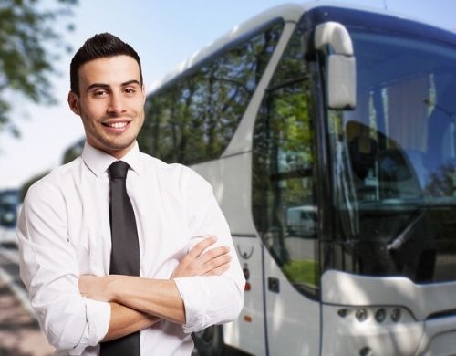bus driver standing in front of a charter bus